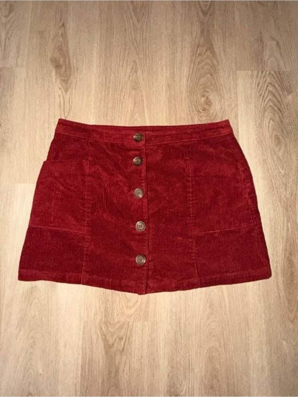 Red high rise corduroy button front skirt. Stretchy corduroy fabric. Functional